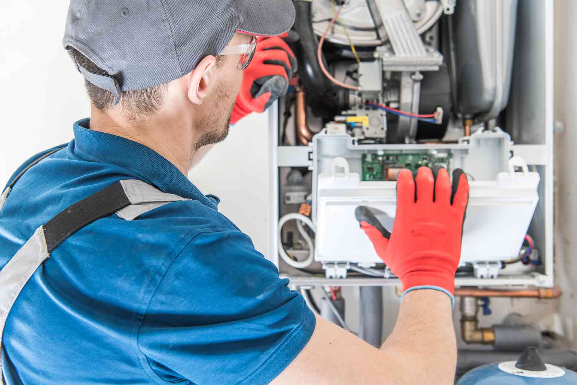 Plumber servicing a boiler in a London home